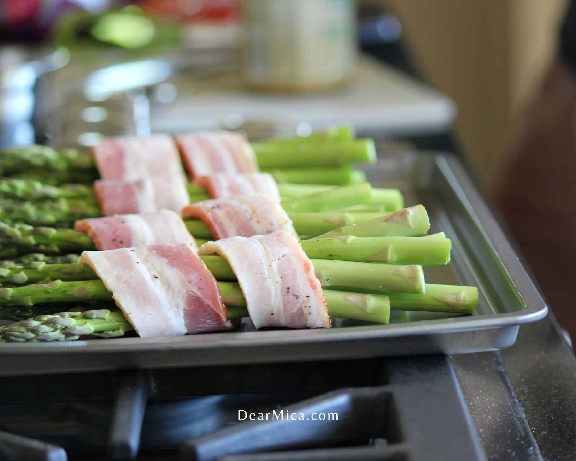 asparagus wrapped in bacon in a baking sheet