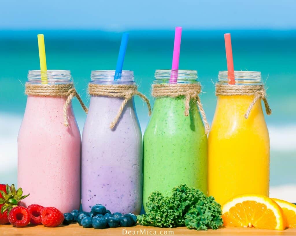 Assortment of low carb smoothies with an ocean background.