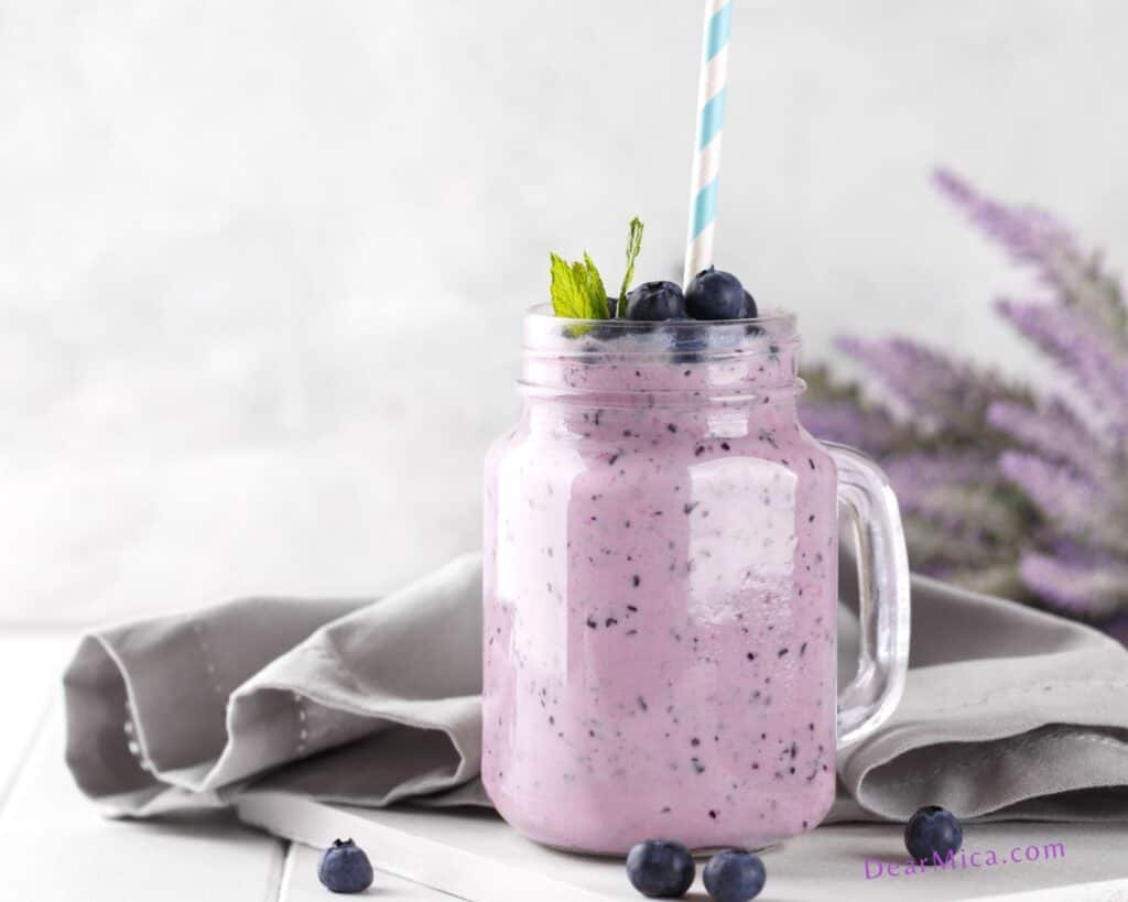 keto Blueberry smoothie in a glass jar garnished with mint and blueberries