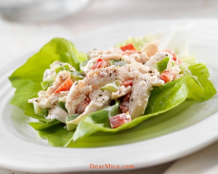 side view of a creamy keto chicken salad lettuce wrap served on a white plate