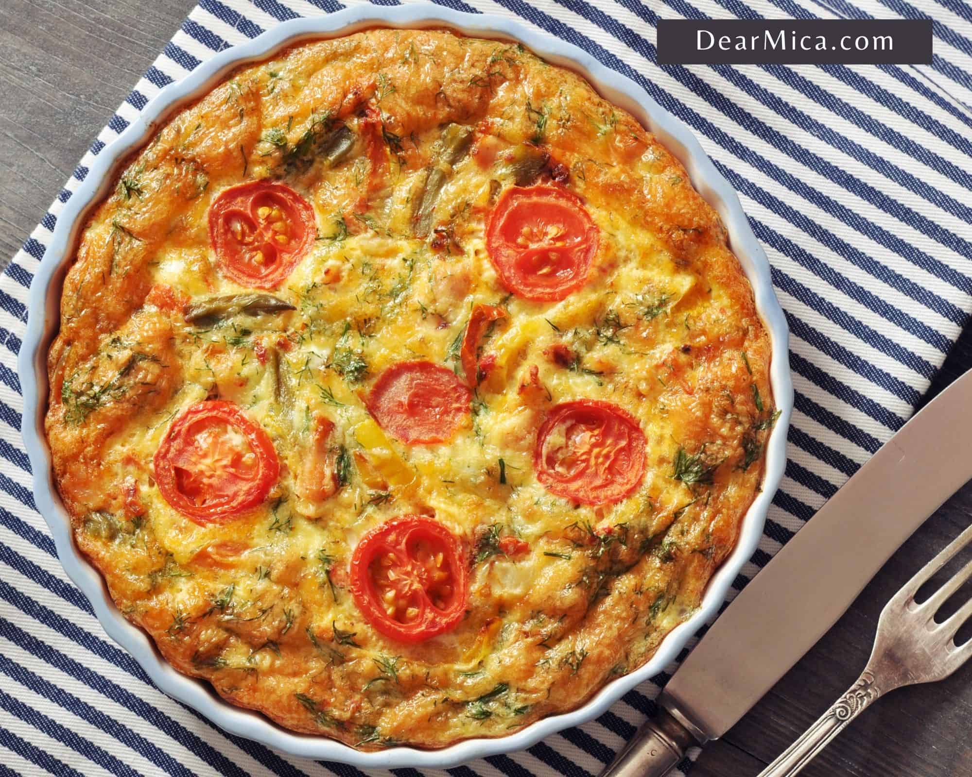 Top view of a low carb turkey frittata with vegetables served on a shallow white baking dish