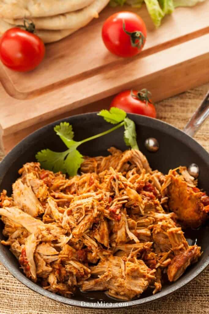 Side view of a Crockpot Chipotle Beef Barbacoa served on a black bowl.