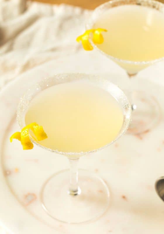 Top view of a  keto lemon drop martini cocktail garnished with lemon skin ribbons.