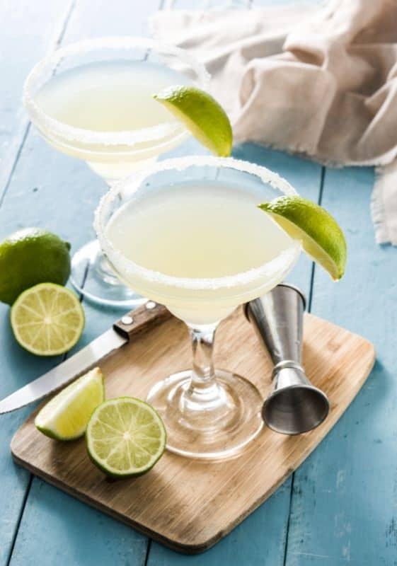 Two glasses of keto skinny margaritas garnished with lime.