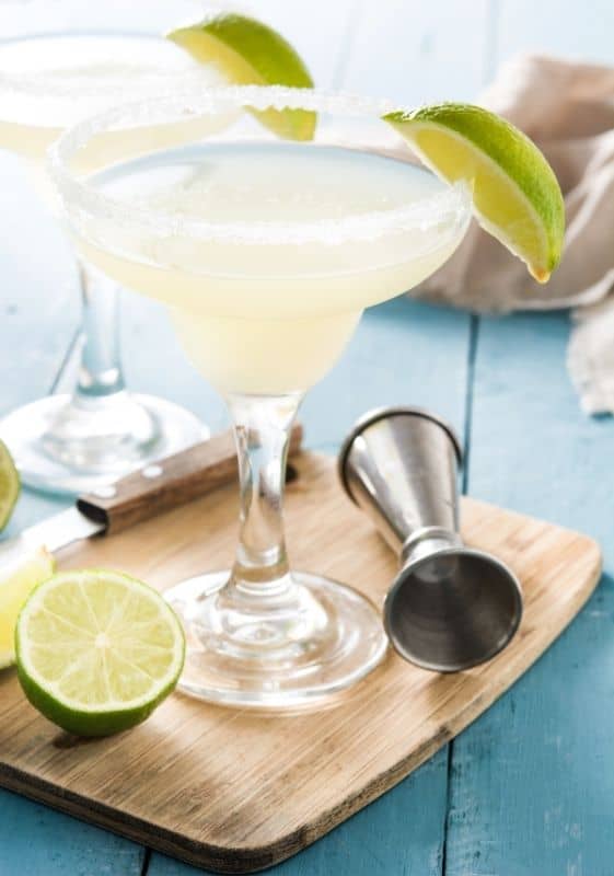 Two glasses of keto skinny margaritas garnished with lime.