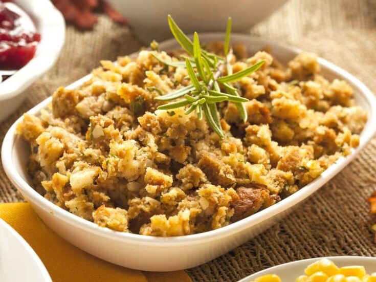 Frontal view of a Low Carb Stuffing For Thanksgiving served on a white platter garnished with rosemary sprig.