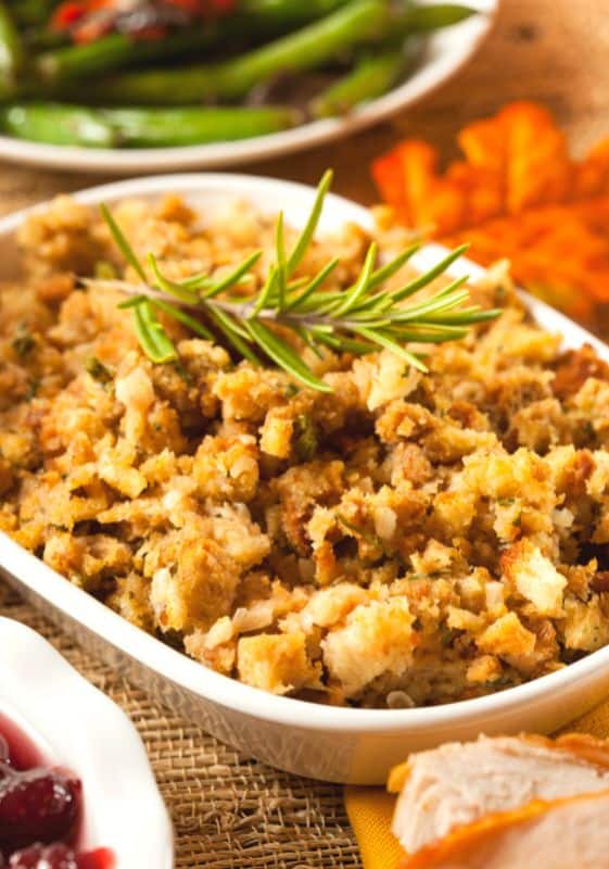 Frontal view of a Low Carb Stuffing served on a white platter garnished with rosemary sprig.