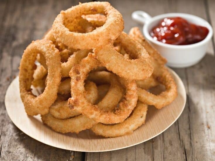 Plate of onion onion rings with ketchup on the side. What To Serve With Keto Onion Rings
