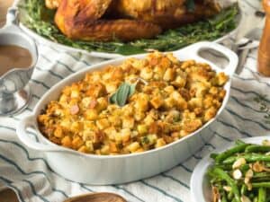 Frontal view of low carb stuffing on a holiday table next to low carb side such as green beans and gravy. What To Serve With Low Carb Stuffing.
